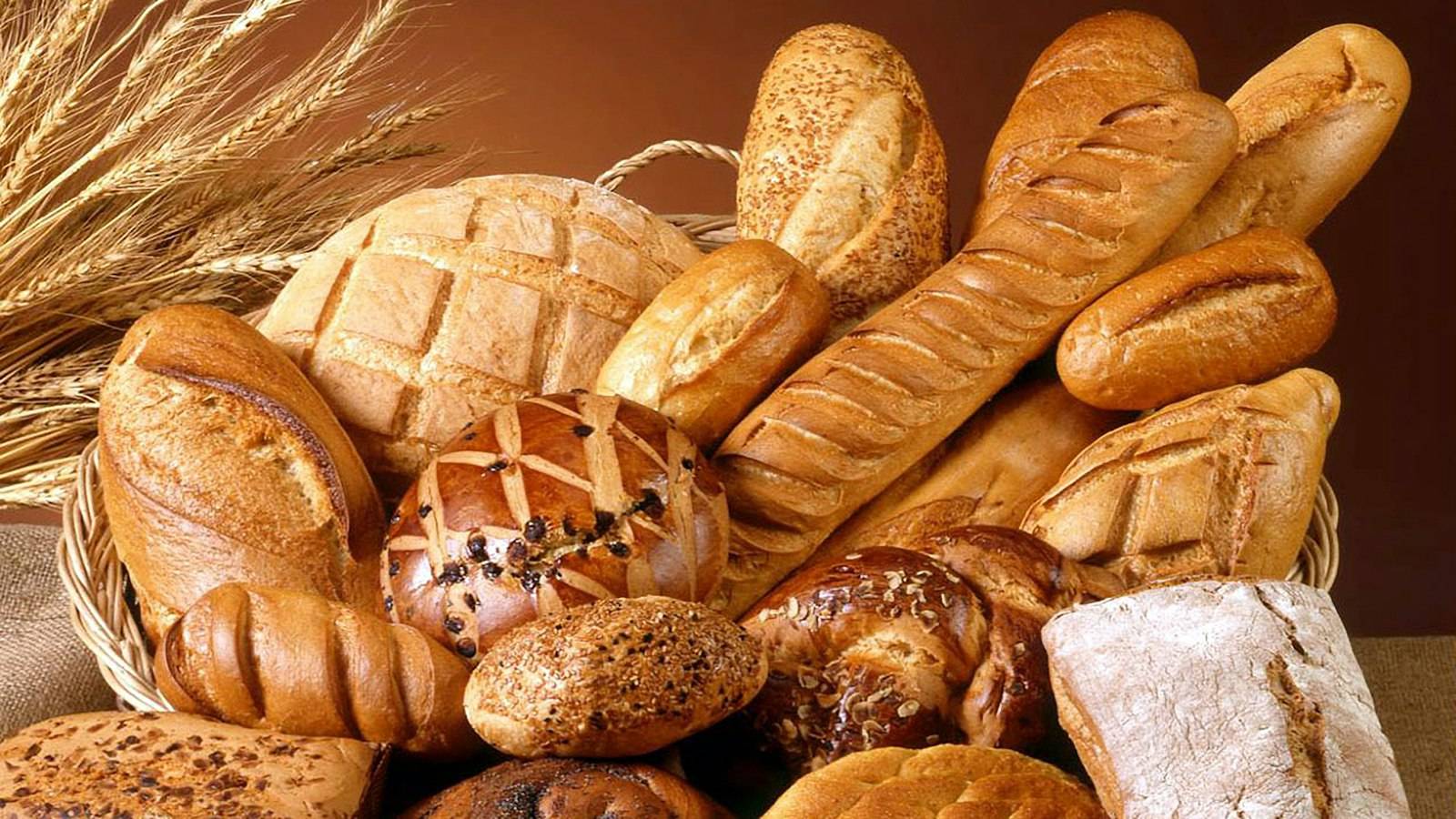 Loaves of bread and baguettes piled in a basket